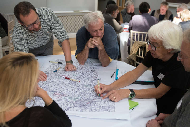 A group of people drawing on a map and discussing river issues at the Catchment Communities Conference in 2018