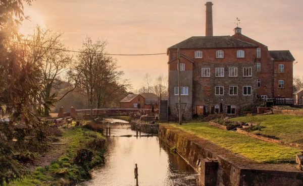 Coldharbour Mill and the River Culm at Uffculme at sunset.