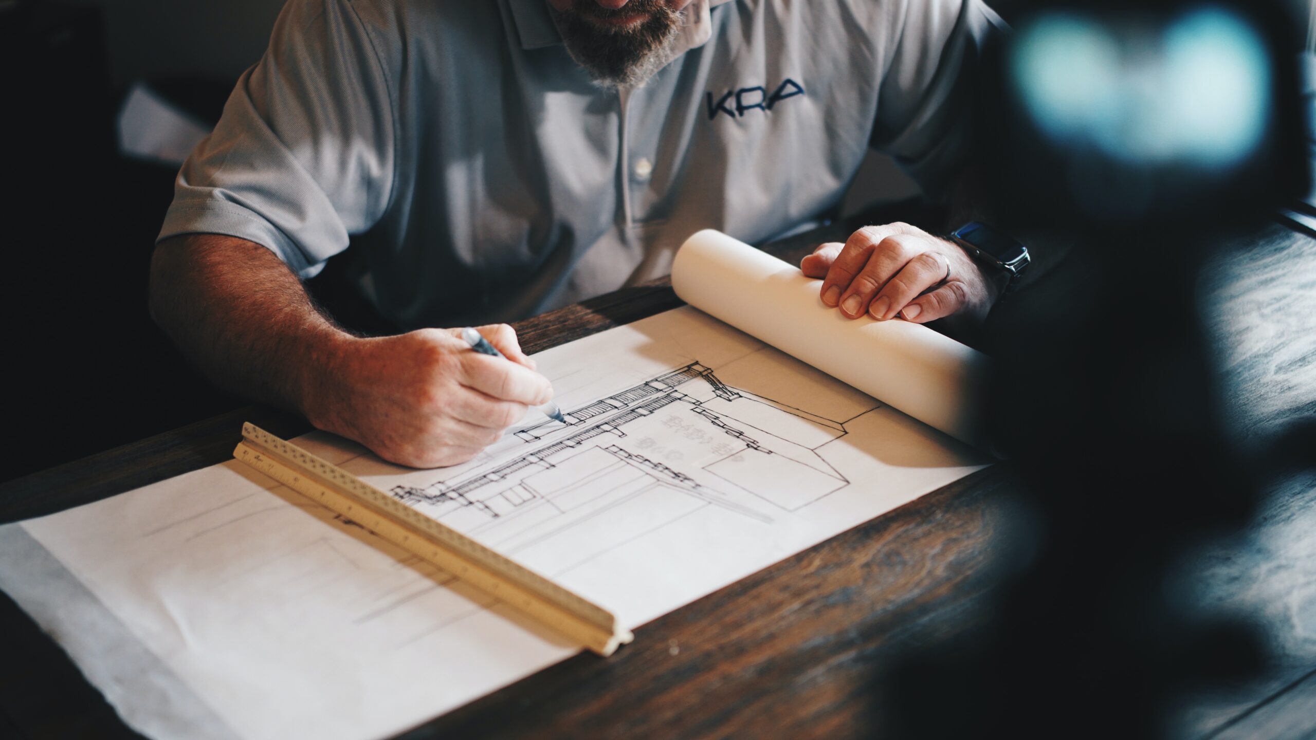 A picture of a man drafting a blueprint