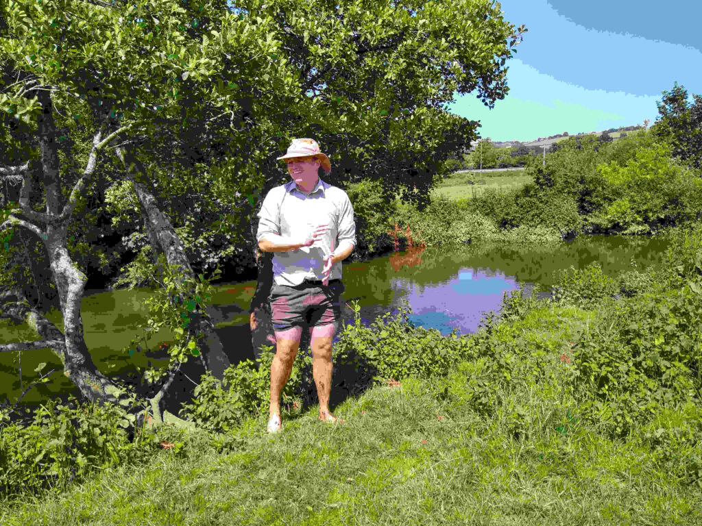 Steven Johnson standing on the river bank