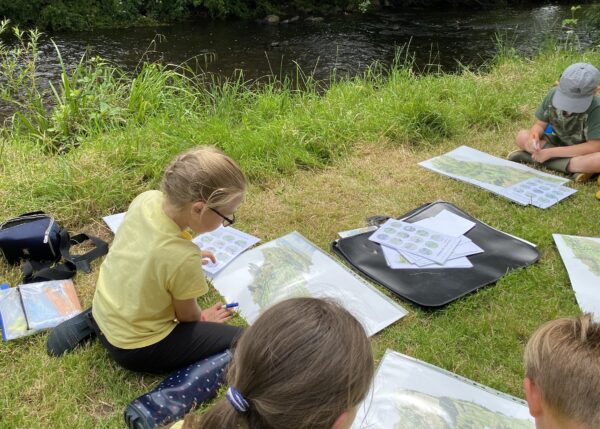 Children working with images of the river culm by the river