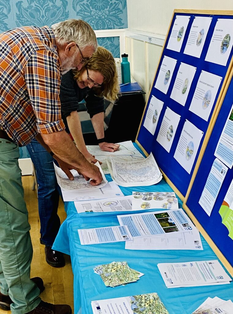 People looking at some information on a stall